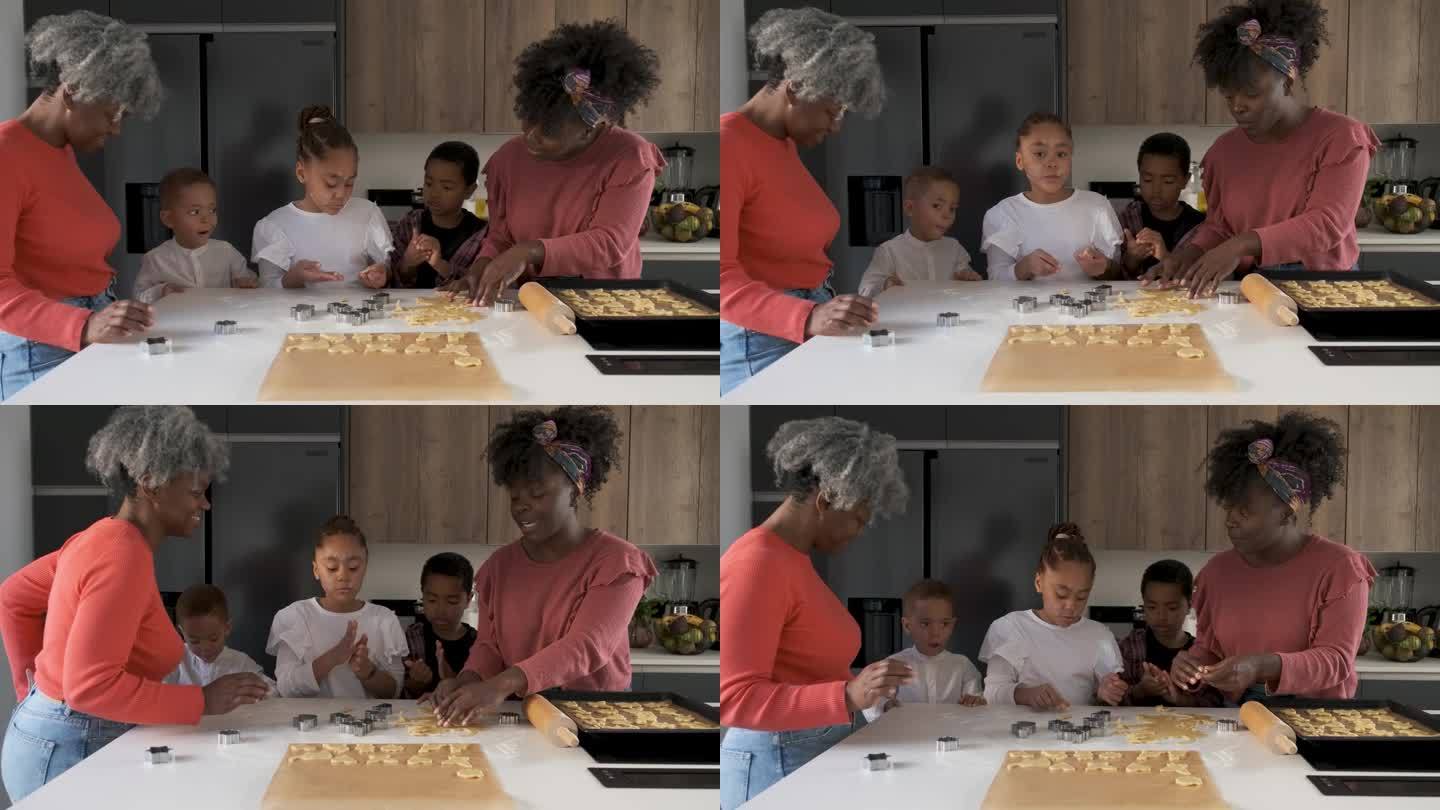 一个非洲家庭在厨房里用饼干面团切饼干的形状。