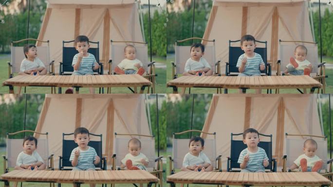 年轻的冒险:亚洲男孩和他的兄弟在户外吃零食，拥抱大自然的美丽