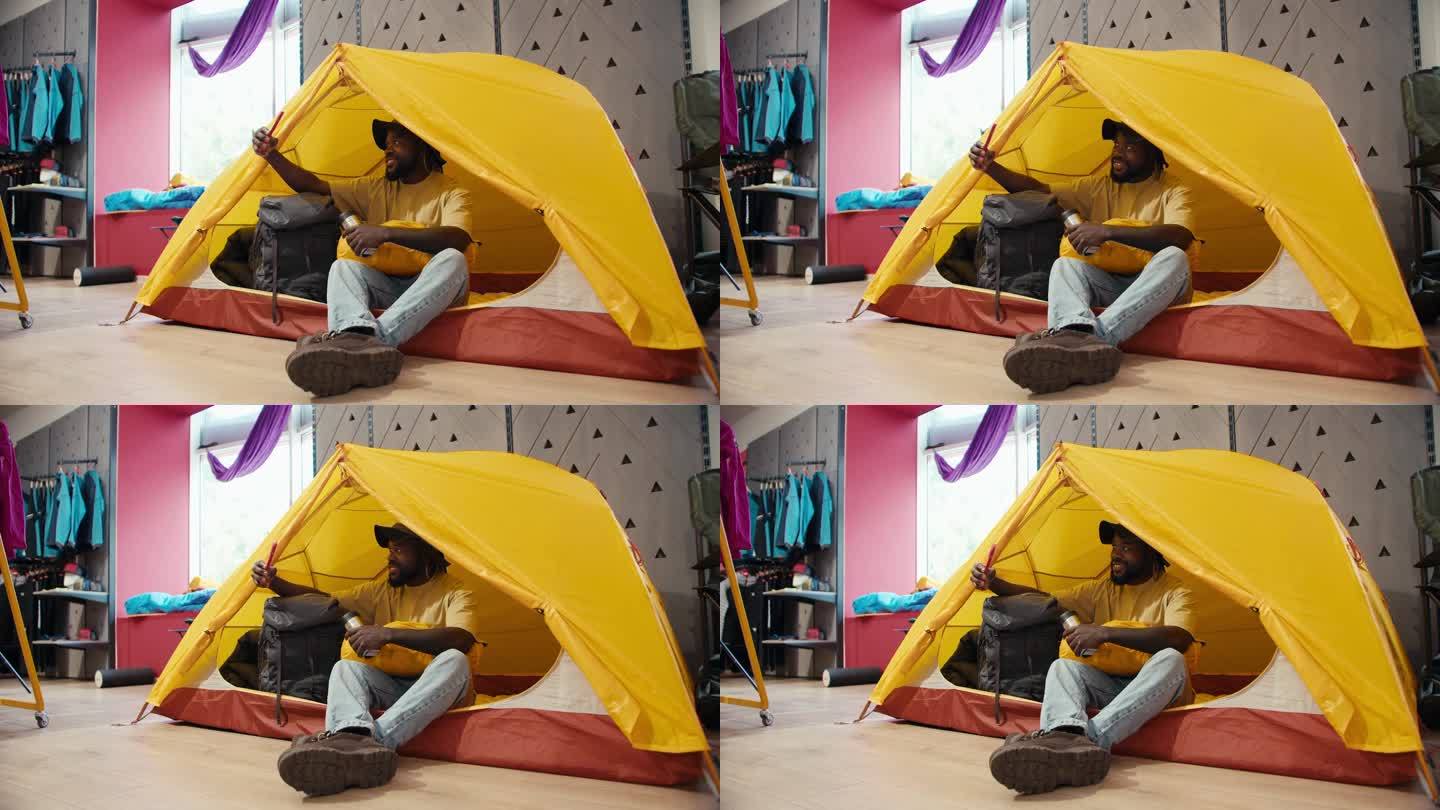 想象的逃离:快乐的非裔美国人露营模拟室内露营冒险在一个黄色的帐篷