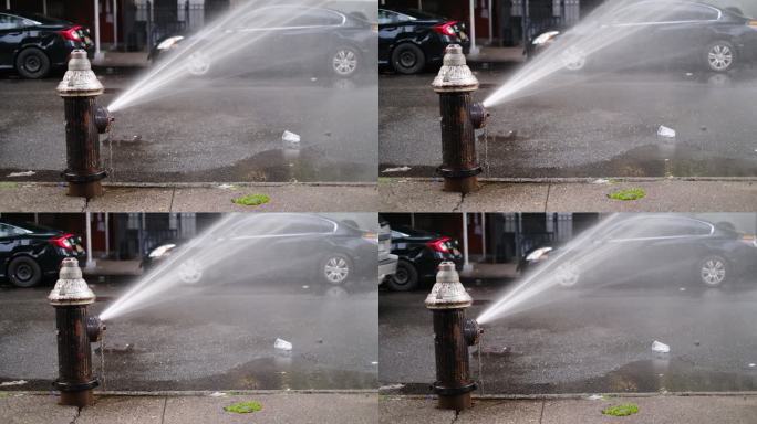 破裂的消防栓在纽约市中城的街道上喷水。