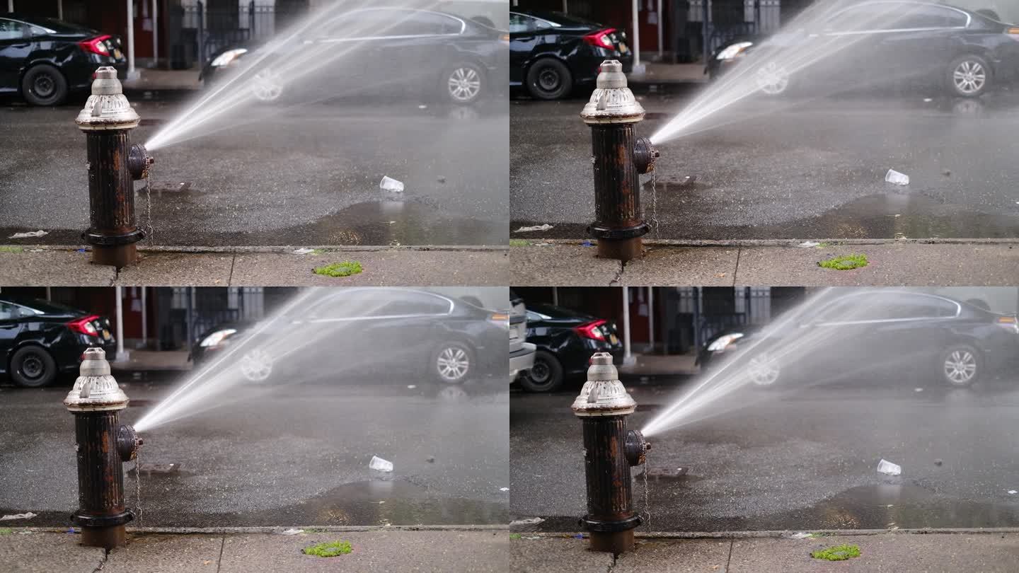 破裂的消防栓在纽约市中城的街道上喷水。