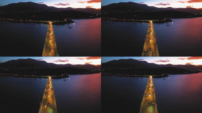 鸟瞰夜间横跨岛屿的桥梁交通