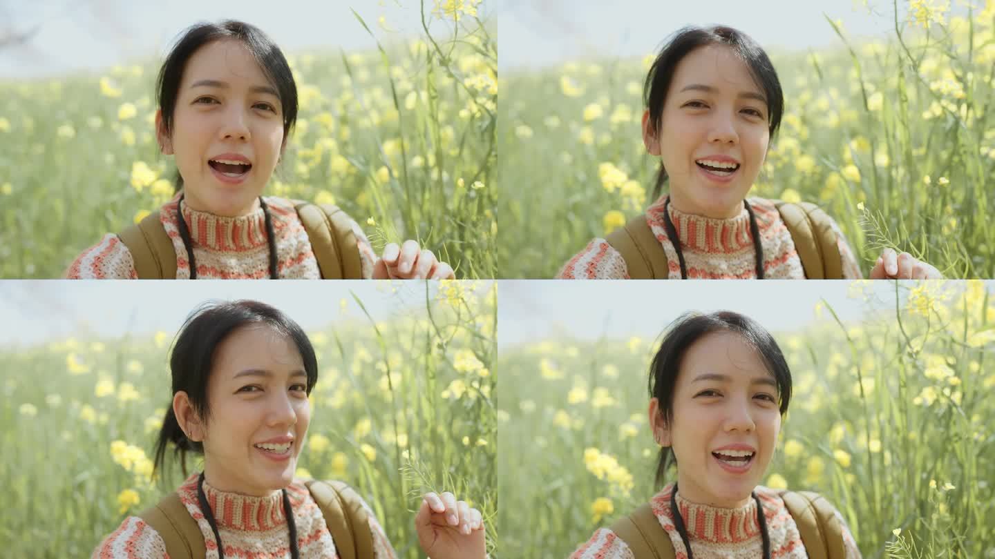 周末，一名女商人站在日本的一片花丛中拍了一段自拍视频。