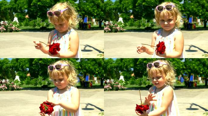 公园里拿着玫瑰花的小女孩