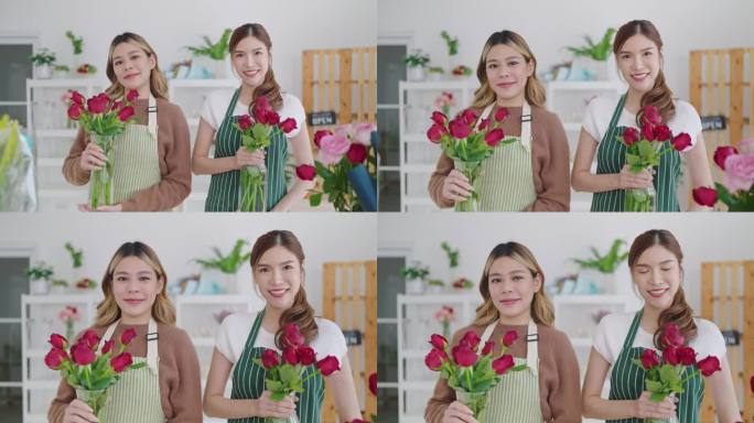 两个漂亮的亚洲女花店在围裙拿着花瓶站在花店，看着相机的肖像。两个亚洲女人开了一家花店。花店概念，小企
