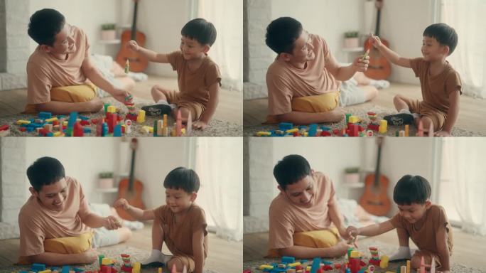 珍惜团聚:亚洲父子在家玩玩具的爱与笑。