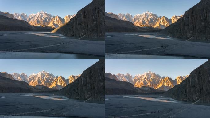 在巴基斯坦北部罕萨山谷地区的帕苏山谷的春天，喀喇昆仑山脉雪山的壮丽景色的延时移动光影日落场景