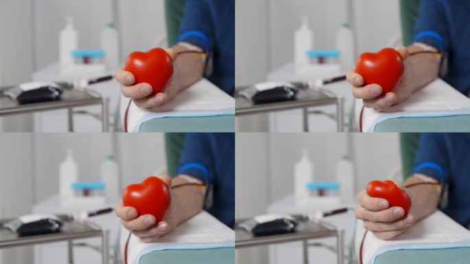 献血者在献血时的特写，手里拿着有弹性的心脏球