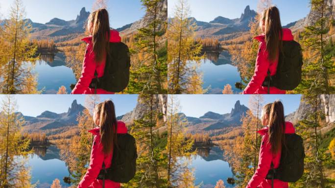 秋天，一位女冒险家正在欣赏山间湖泊的壮丽景色