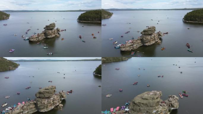 乘坐双体船和小船乘船旅行。朱姆巴克塔斯石岛位于哈萨克斯坦波罗沃州的一个山湖中央。水中央的岩石是哈萨克