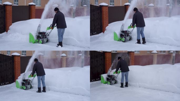 冬天，一个人在房子的院子里打扫雪，一个人用吹雪机打扫雪