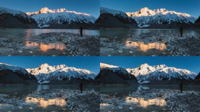 延时拍摄的人在雪山上观看第一缕阳光，湖面反射静止