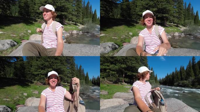 一位兴高采烈的女游客正在用视频记录她的森林山河之旅。自拍的观点