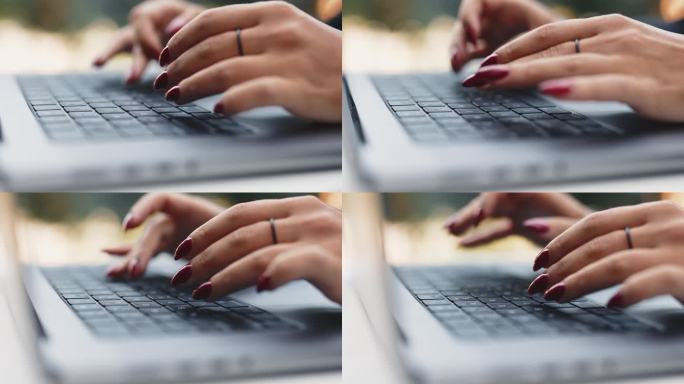 女人的手在键盘上打字，特写侧视图。在笔记本电脑键盘上打字。精心修饰的女人的手。在电脑上工作的女商人