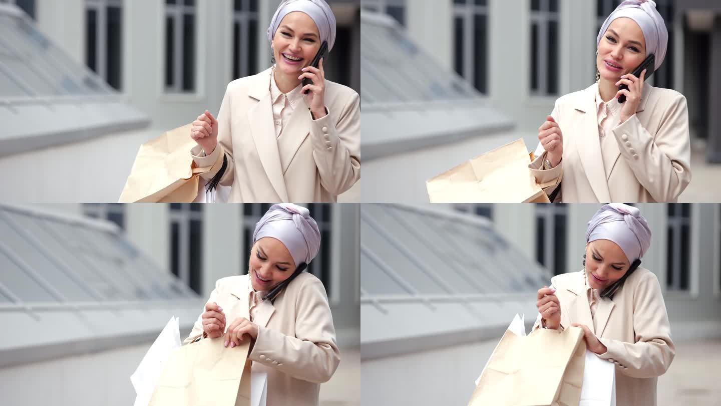 穆斯林女商人通过智能手机与女友通话