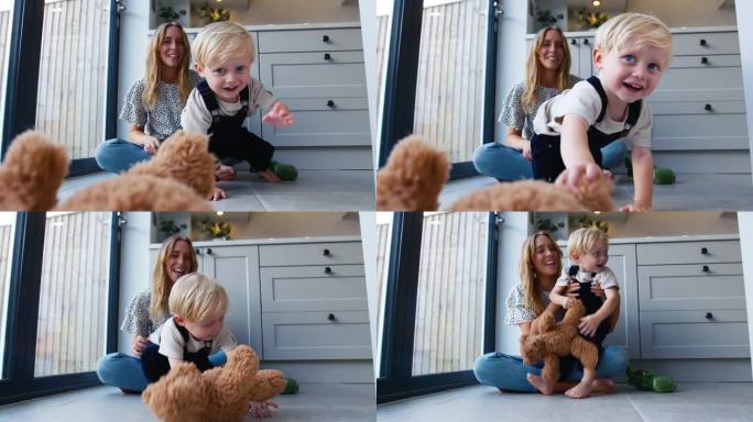 慈爱的母亲与年幼的儿子和玩具一起坐在家里厨房的地板上玩游戏