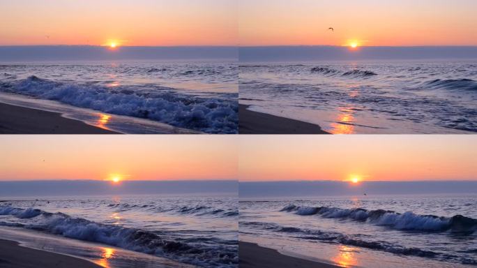 海边美丽的日出。太阳从地平线上的天空云后升起，在蓝色的大海上，海浪在沙滩上翻滚。美丽的海景海景。自然