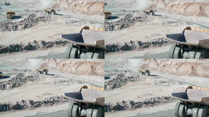 大型采石场自卸车在露天矿山运输矿石，慢动作