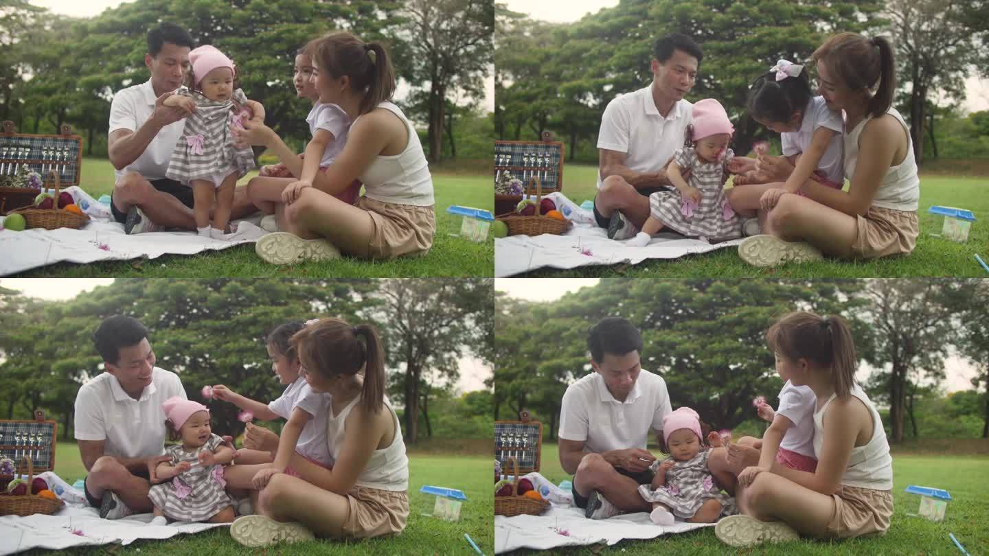 一个快乐的家庭在野餐时和他们的孩子玩耍