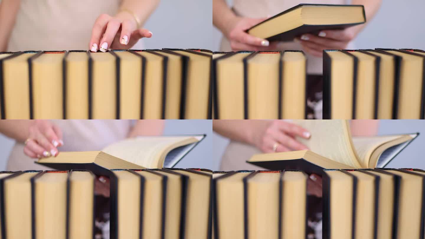 女人的手在书架上挑书。