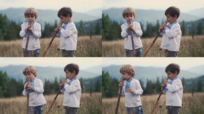 小男孩在喀尔巴阡山脉的草地上演奏木管木笛-乌克兰索皮卡。二重唱民乐概念。孩子们穿着传统的刺绣衬衫。