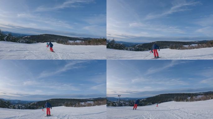 两个滑雪者从高山滑雪道上下来