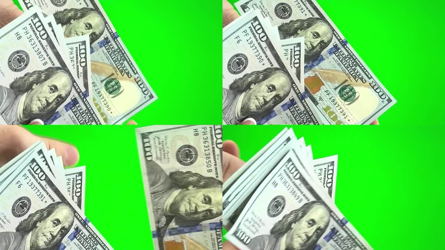 在绿色背景上，铬色男性的手给女性的手一百美元的钞票，女性计数每一张钞票考虑其真实性，表示大拇指快乐交