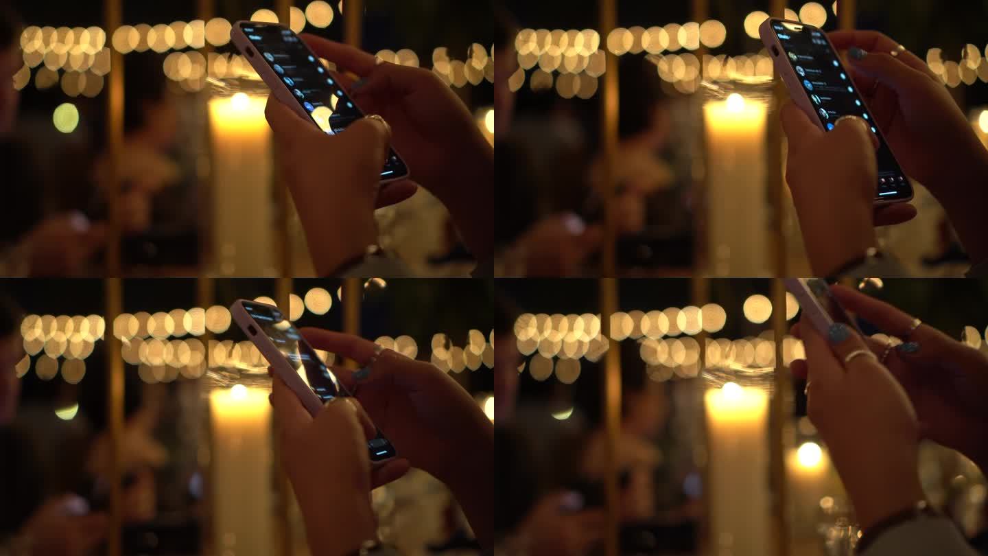 美丽的手，指甲和戒指在智能手机上呼唤公园里的婚礼浪漫晚餐