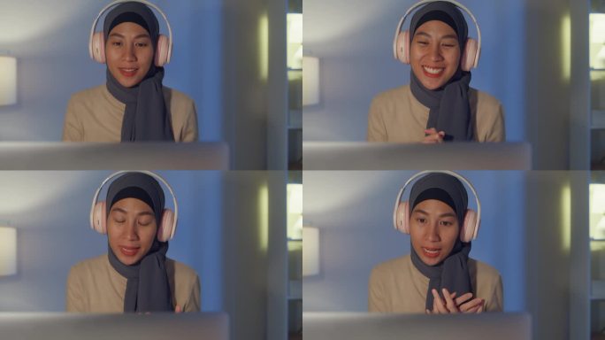 特写年轻快乐的亚洲穆斯林女商人脸戴头巾休闲布在家里用笔记本电脑视频会议晚上加班工作。小企业主在线营销