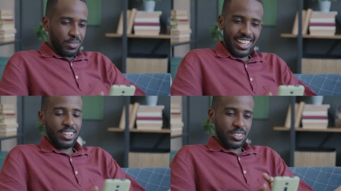 友好的非洲裔美国人在家里用智能手机摄像头在线视频通话时挥手致意