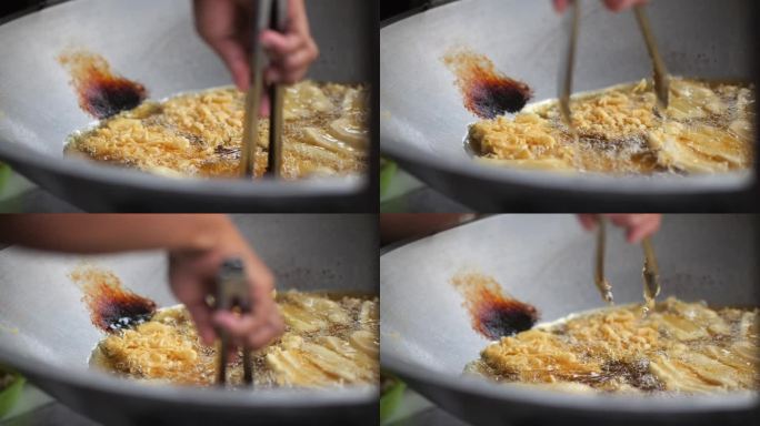 街边小贩在做印尼脆皮香蕉油饼。街头食品。当地食物。Makang pisang goreng。