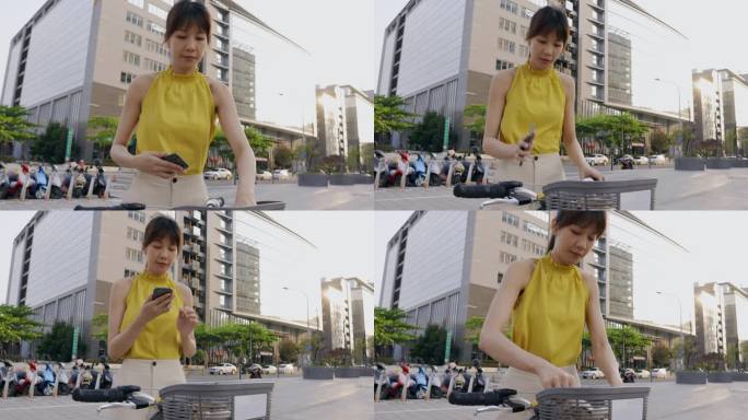 在香港，一名亚洲女性正在用手机扫描共享单车的二维码，准备租用和使用。
