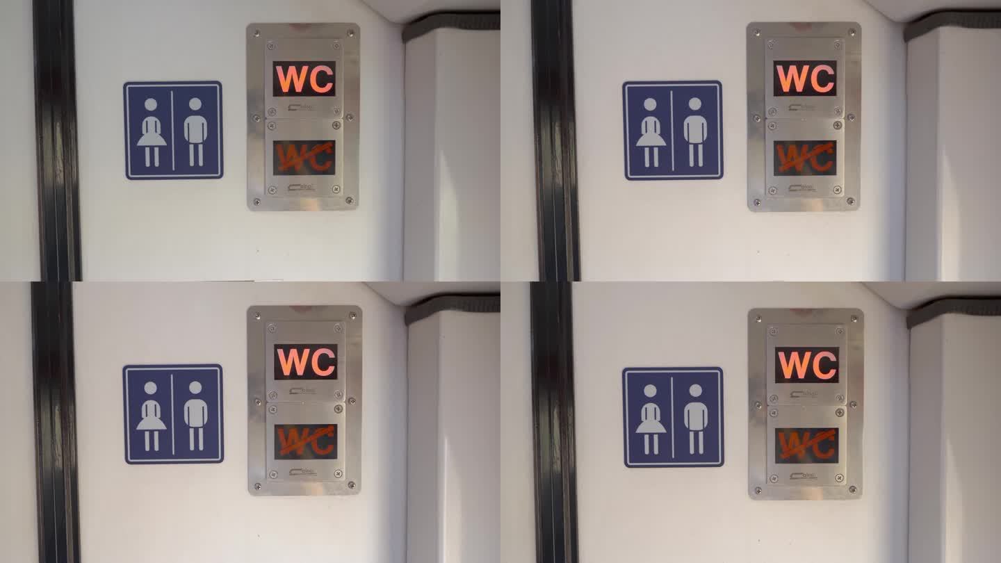 4K镜头的厕所入口，闪烁的霓虹灯和男女标志在火车上的板。
