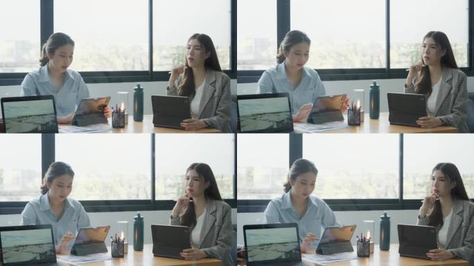两个年轻的女商人在会议室用笔记本电脑讨论项目