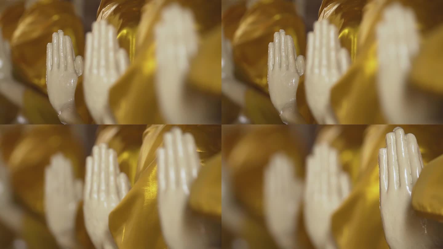 披着金黄色袈裟的佛像的手。