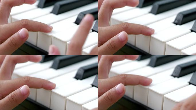 女孩用手指弹钢琴。