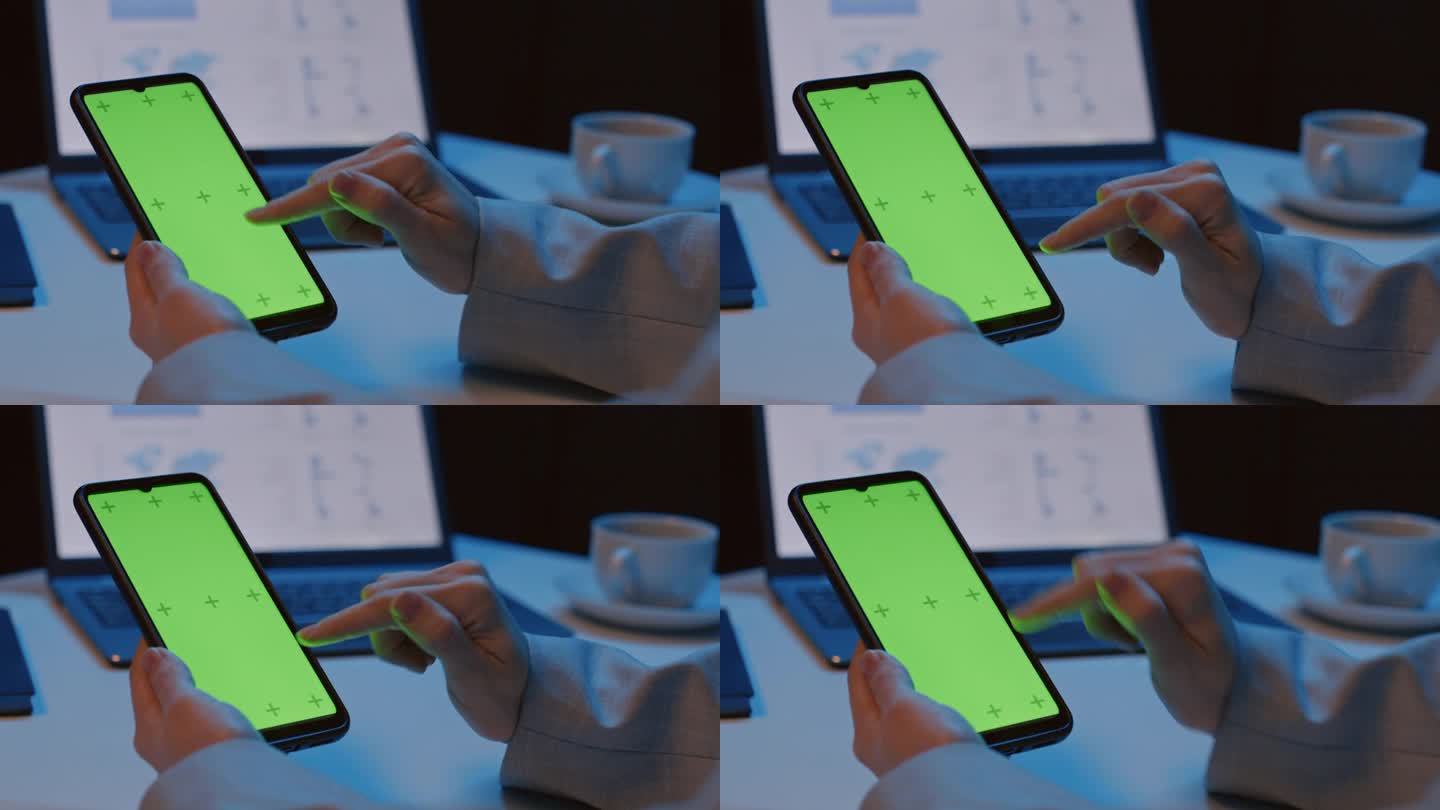 女子手持绿色屏幕的智能手机并进行滑动
