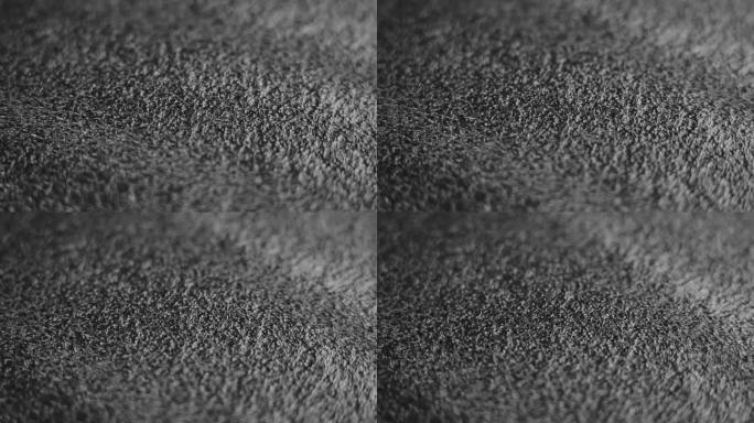 黑色多孔软化保护包装塑料材料，表面有海绵状纹理。旋转