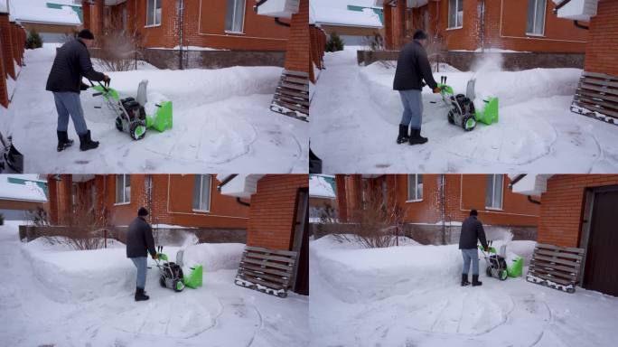 冬天，一个人在房子的院子里打扫雪，一个人用吹雪机打扫雪