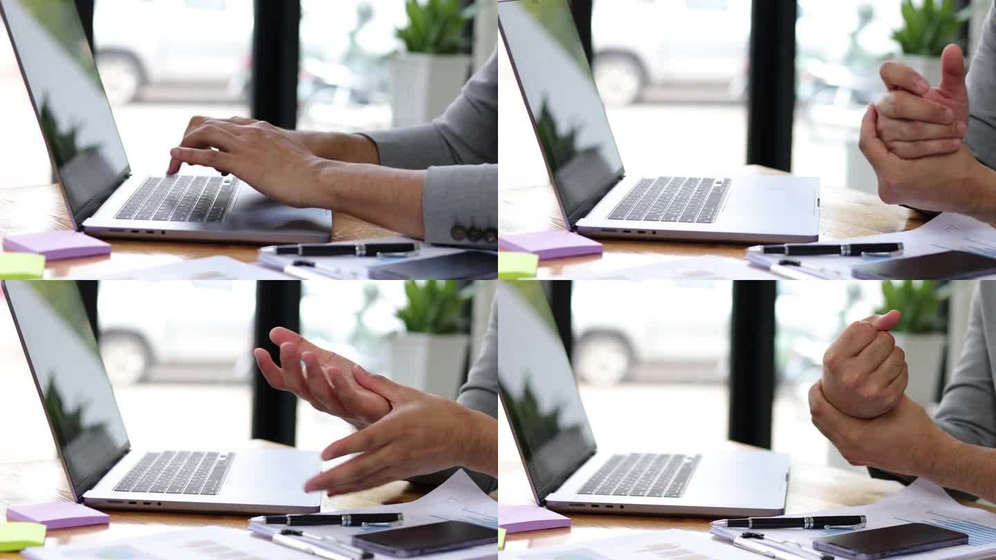 在办公室打手提电脑的商人患有慢性手痛和手腕痛。