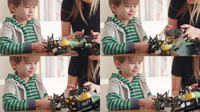 小学生在教室里。男孩玩机器人玩具玩得很开心，在教室里练习组装机器人，老师给予建议和照顾。提高工程技能