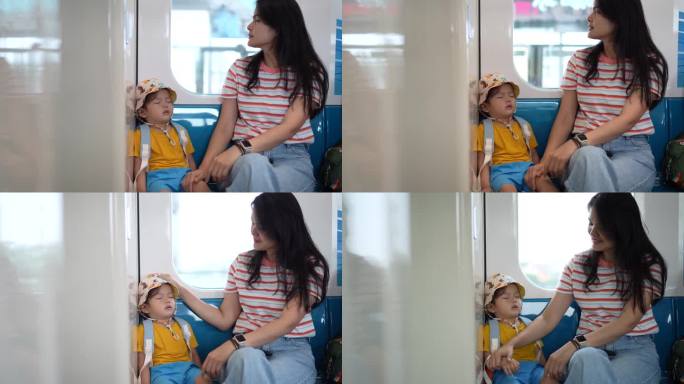 亚洲母亲和她可爱的小儿子享受火车旅行