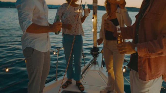 朋友们在船上拿着烟花，用啤酒瓶敬酒
