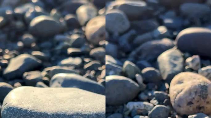 相机慢慢地漂浮在太平洋的岩石海滩上，显示每一块石头的任何背景，为放松Parksville海滩Surf