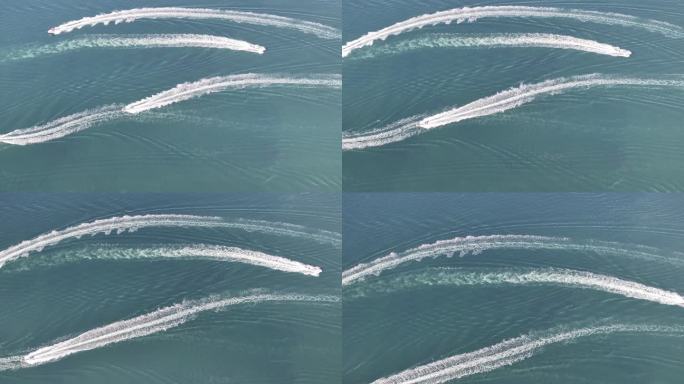 航拍俯瞰威海双岛湾海面上高速航行的快艇