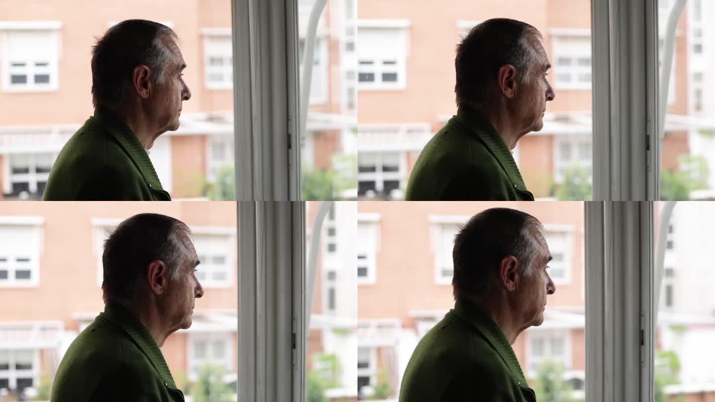 有老年痴呆症和抑郁症的老人，侧身看着窗外。老年，疾病，孤独，健忘和记忆的概念。