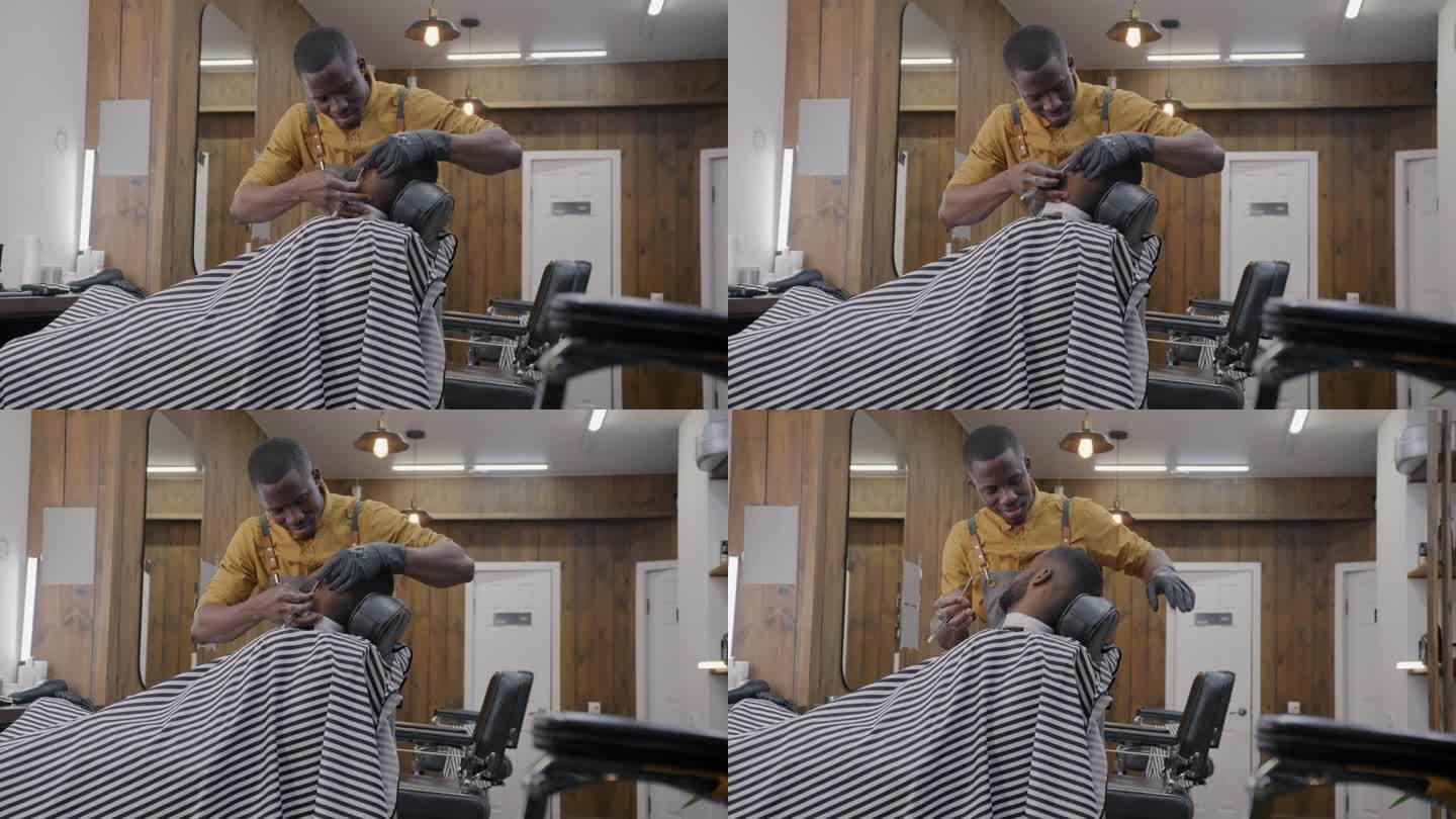 专业理发师在理发店里给非裔美国人刮胡子，微笑着与顾客交谈