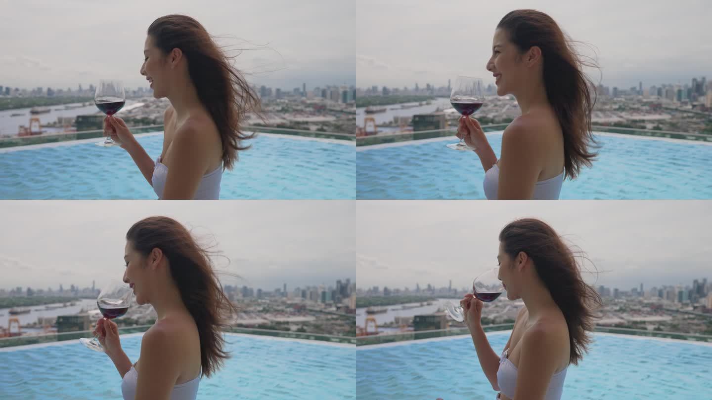 美丽的亚洲女性游客在酒店的屋顶感到快乐和自由。