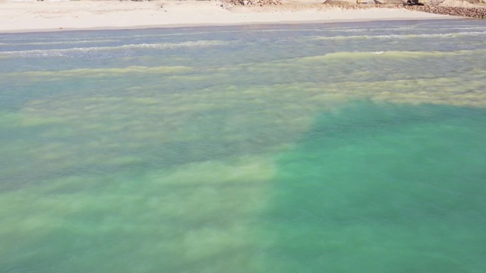 白色的沙滩，绿色的海水，海浪拍打着沙滩，大西洋