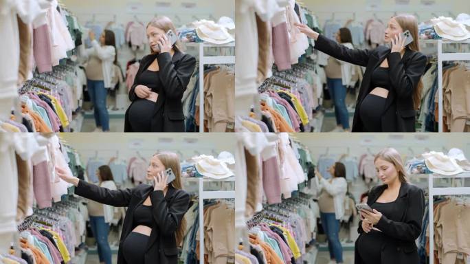 孕妇拿着手机在童装店选购婴儿服装